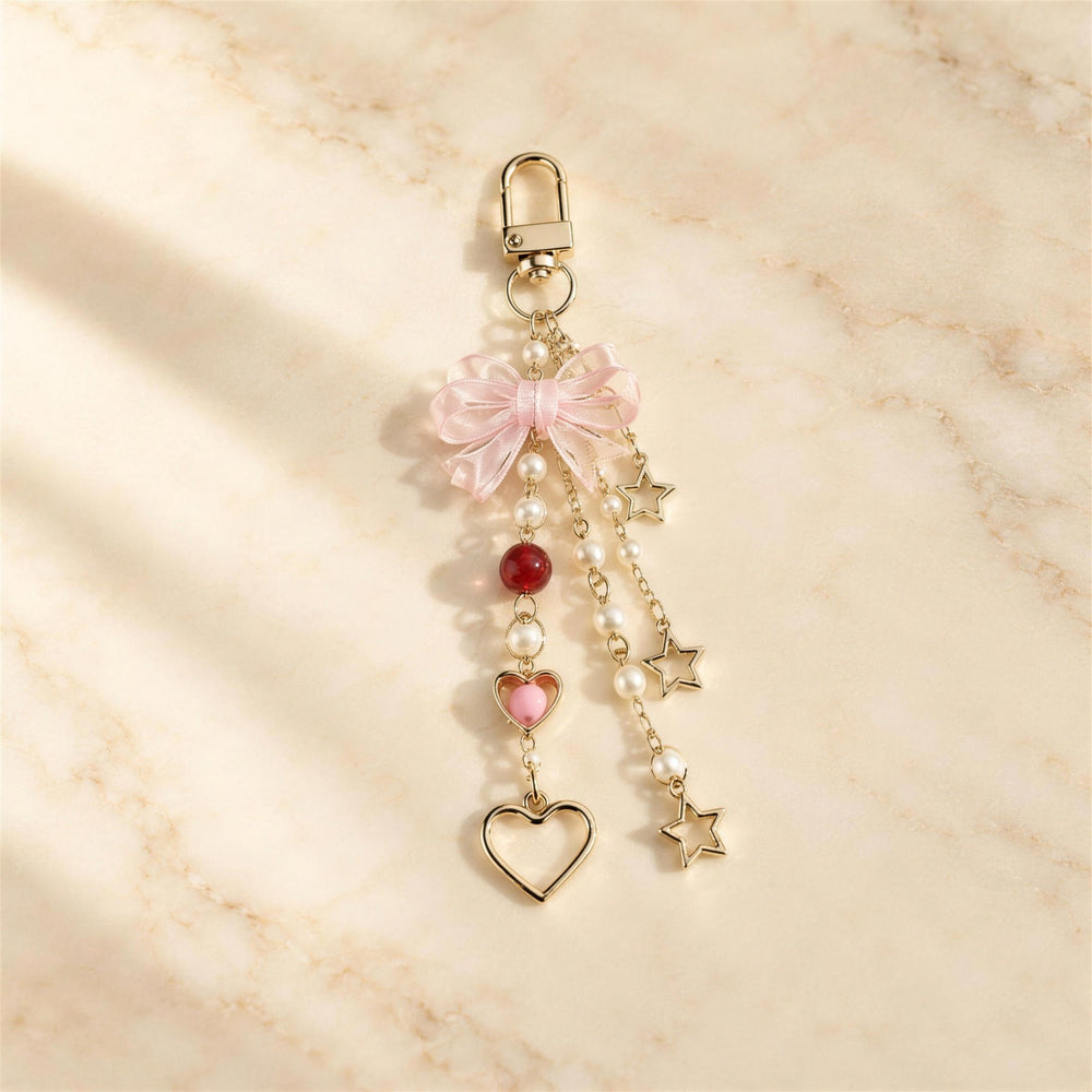 Bow & Star pearl bead phone charm on marble