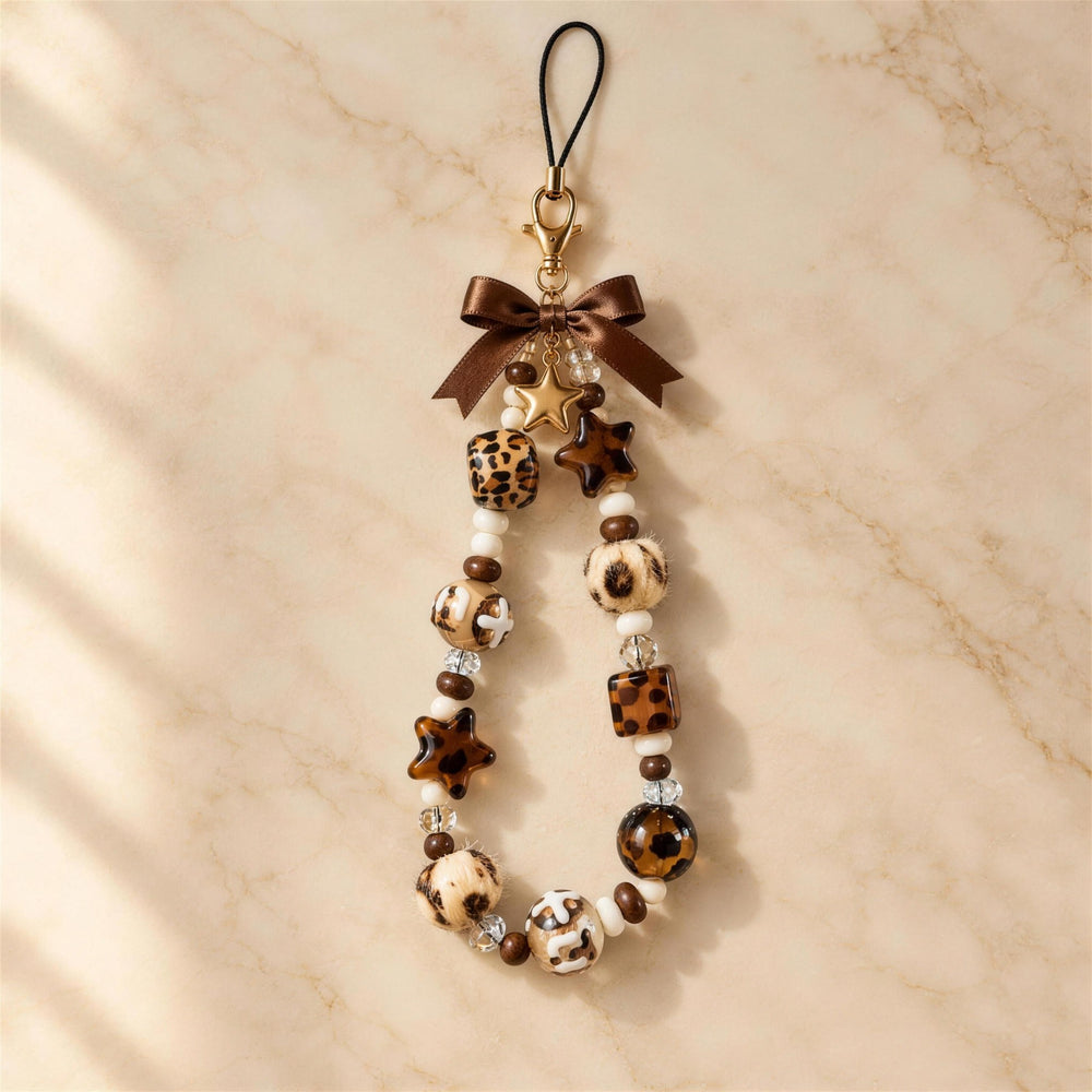 Leopard Star beaded phone charm on marble